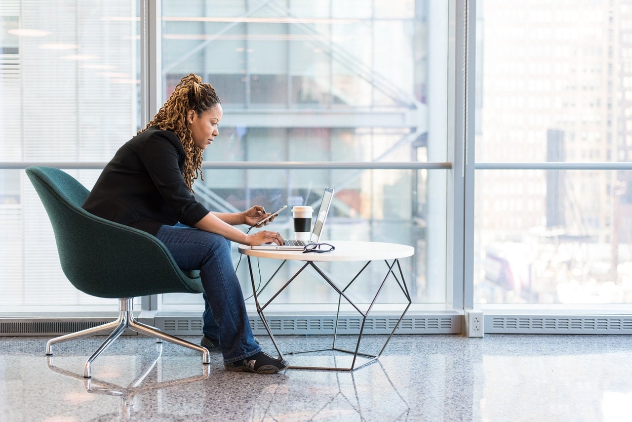 woman working on laptop by window